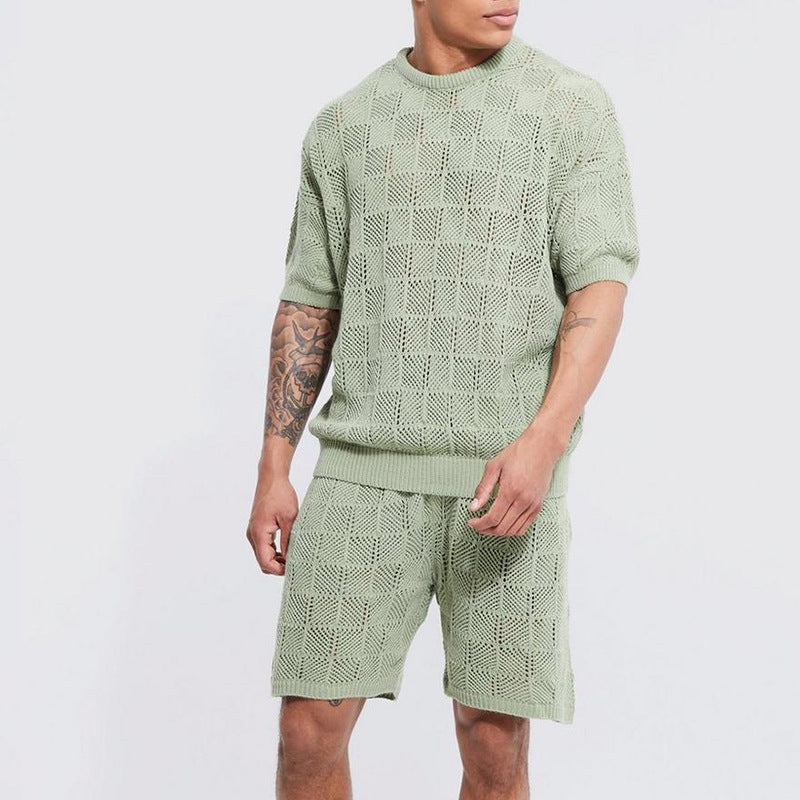 A person wearing a matching sage green casual 2 piece set—short sleeve shirt and shorts—with a geometric open-knit pattern, standing against a plain light background.