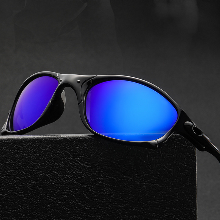 A pair of black cycling sunglasses with a rectangular frame and reflective blue lenses rests on a textured black surface against a dark background, offering stylish UV400 protection.
