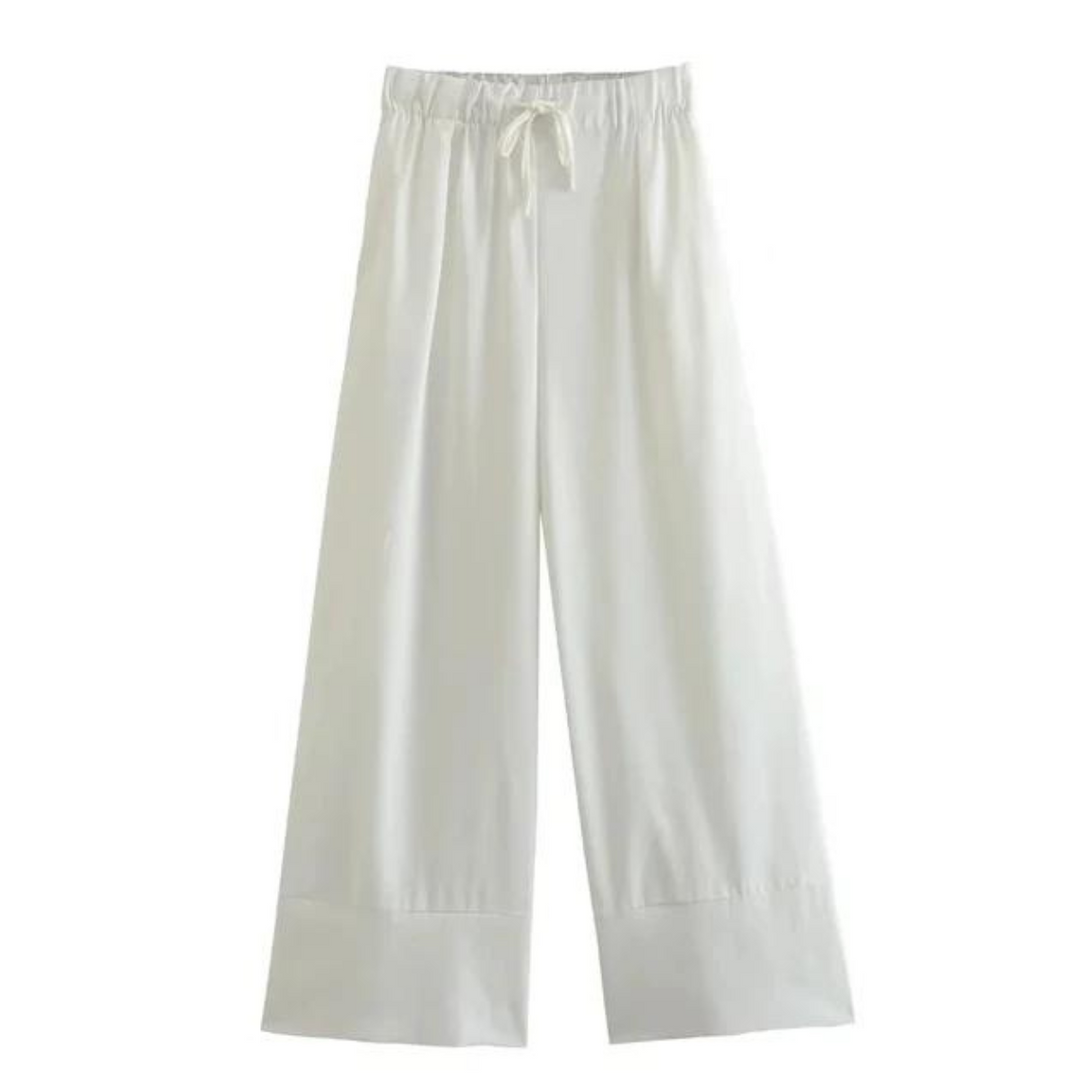 Wide-leg white pants with an elastic waistband and drawstring tie, perfect for a relaxed summer style. Displayed on a plain background, these wide-leg pants feature a loose fit and simple design.