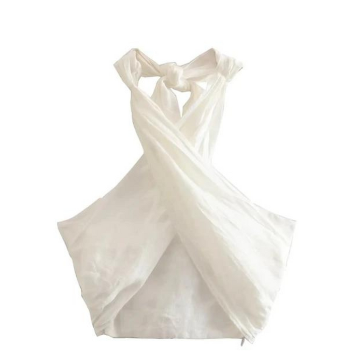 A white, sleeveless, cross-back apron made of lightweight fabric, perfect for a breezy summer style. Displayed on a plain white background, it features wide straps that cross and tie at the back.