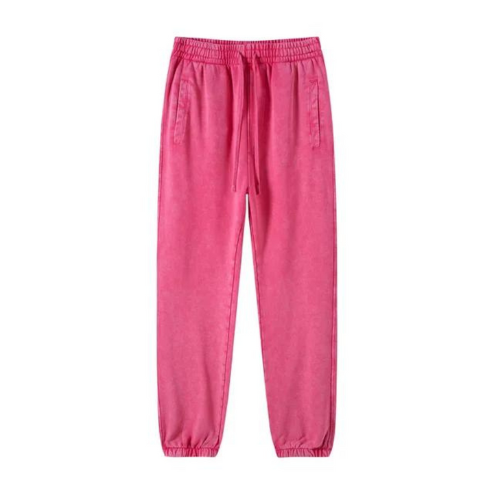 Bright pink sweatpants with an elastic waistband, adjustable drawstring, deep pockets, and tapered cuffs at the ankles, laid flat on a white background.