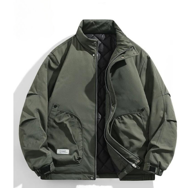 Olive green bomber jacket with a stand-up collar, zip front, snap buttons, two angled side pockets, black quilted inner lining, adjustable cuffs, and a small white label on one pocket, displayed on a white background.