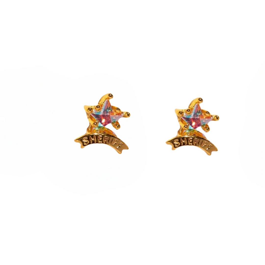 A pair of gold sheriff badge-shaped statement earrings with multicolored gemstones and the word SHERIFF engraved on a banner below each star.