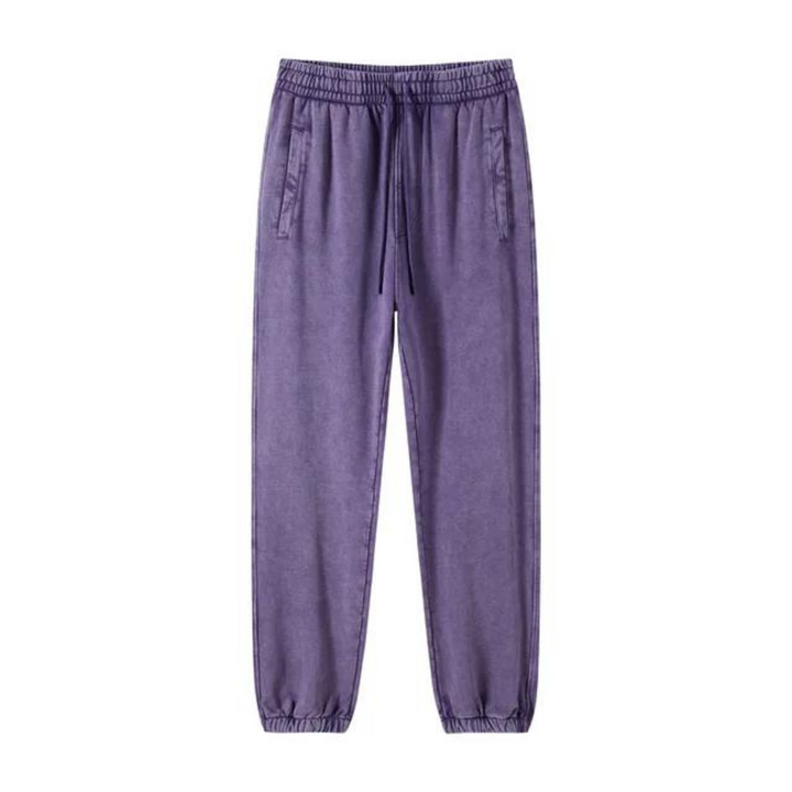 Purple jogger pants with an elastic waistband, deep pockets, drawstring, and tapered cuffs, displayed against a plain white background.