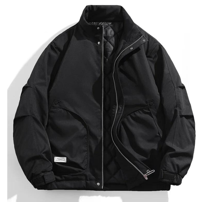 A black bomber jacket with a high collar, front zipper, snap buttons, quilted inner lining, and two large side pockets. The windproof jacket features ribbed cuffs and is displayed against a white background, one side partially unzipped.