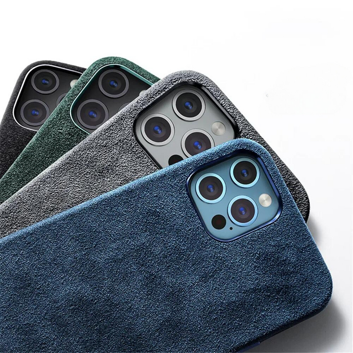 Four smartphones in textured alcantara phone cases—blue, gray, green, and black—are arranged diagonally with their camera lenses visible, showcasing the suede finish of each protective design against a white background.