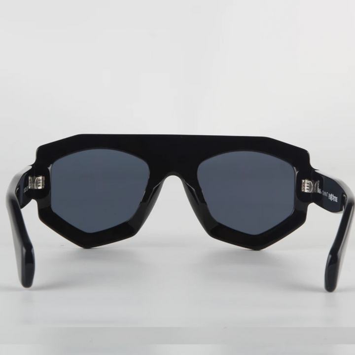 A pair of black, geometric frame sunglasses with dark lenses is shown facing forward on a white background. The thick acetate edges and angular corners give them a modern, bold style, while offering reliable UV400 protection.