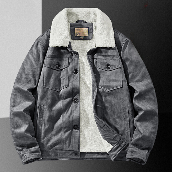 A gray suede jacket with a structured fit, white Sherpa lining and collar, front button closure, multiple secure pockets, displayed on a divided black and gray background.