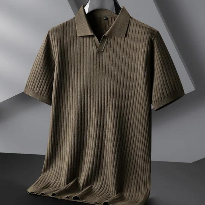 A short-sleeved, ribbed knit polo shirt in olive green hangs on a black hanger against a modern, geometric gray background—perfect for the urban professional seeking effortless style.