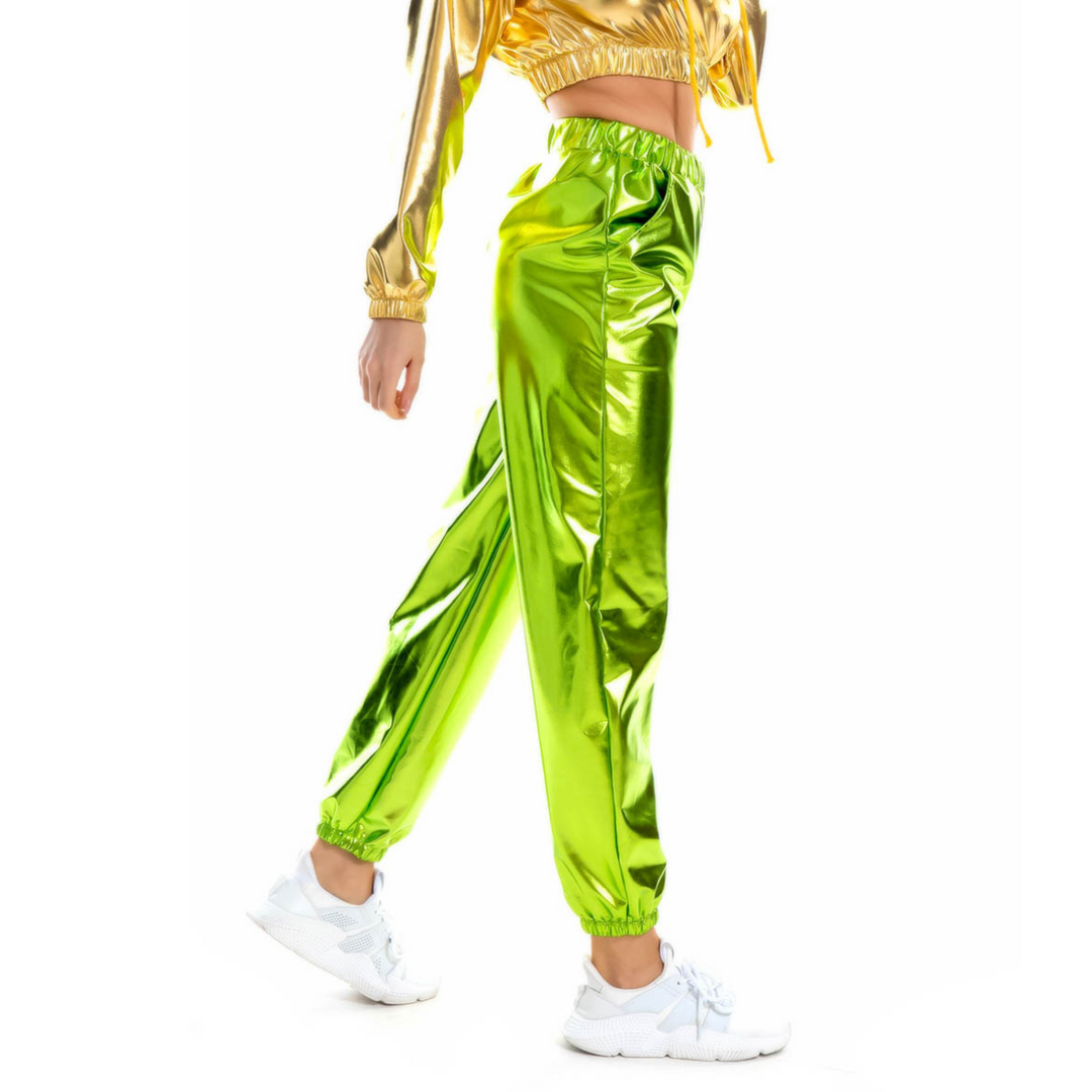 A person wearing shiny green pants with a holographic finish and an elastic high waist.