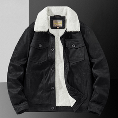 A black suede jacket with a white sherpa fleece collar and inner lining, featuring a structured fit, buttoned chest pockets, and front buttons, displayed on a color-blocked background.