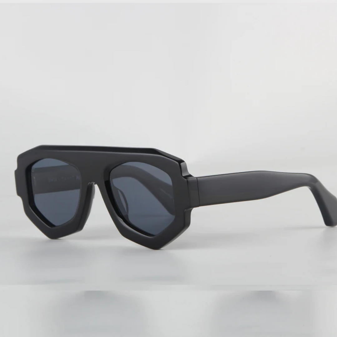 Black geometric sunglasses with thick, angular acetate frames and dark lenses, offering UV400 protection, displayed on a white background.
