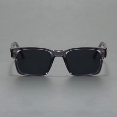 A pair of rectangular, black sunglasses with thick, translucent gray frames and modern design, offering UV400 protection, displayed against a plain gray background.
