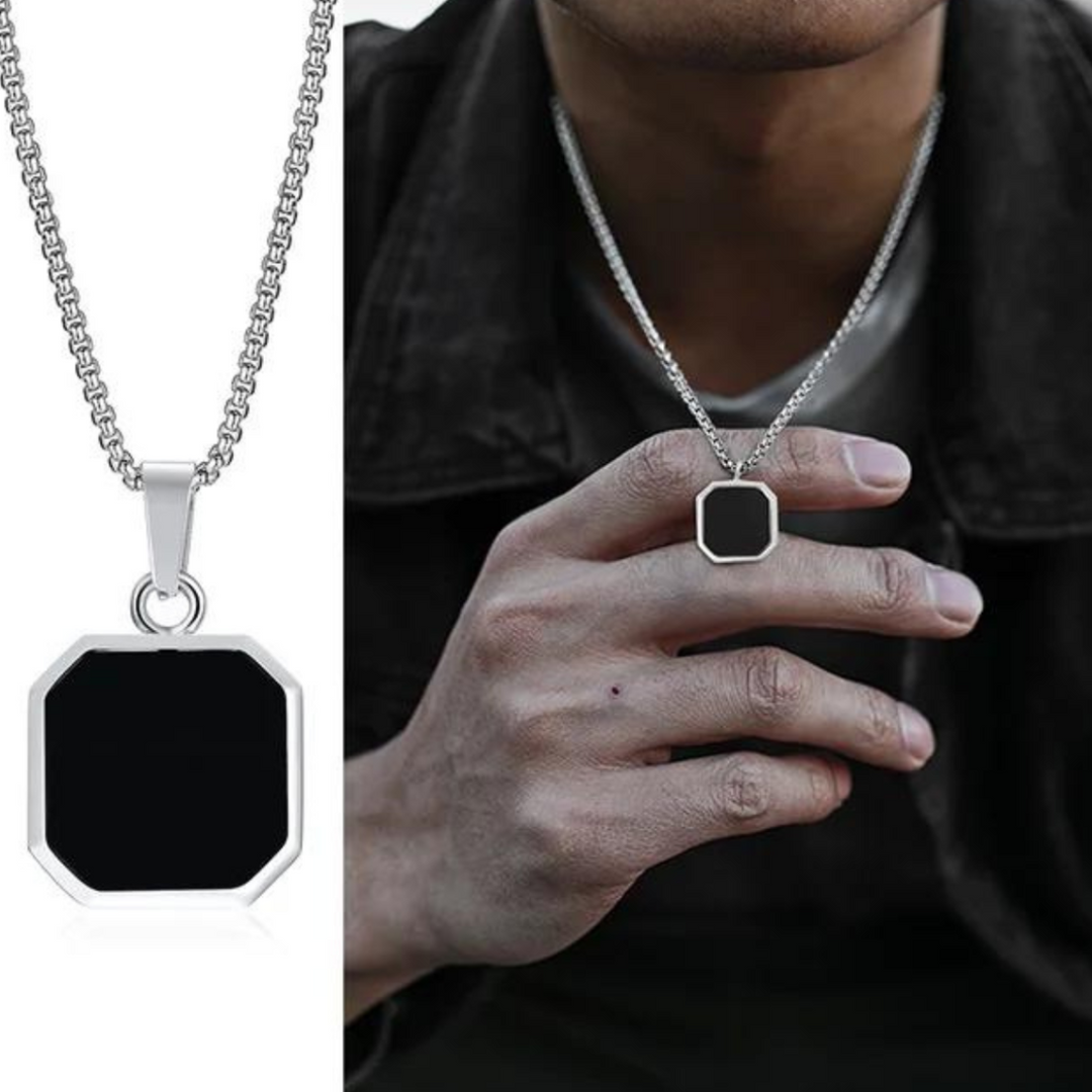 A man wearing a silver chain necklace with a large, black octagonal pendant is shown. A close-up of the Onyx Stone Amulet on the left highlights its geometric shape and glossy finish, making it striking collectable jewelry.