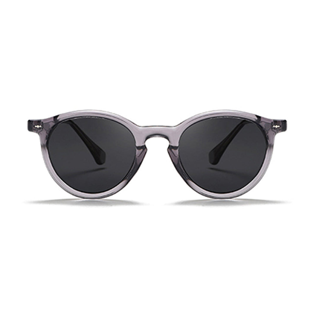 Fashionable eyewear featuring round frame sunglasses with translucent gray frames and dark tinted lenses, shown against a white background.