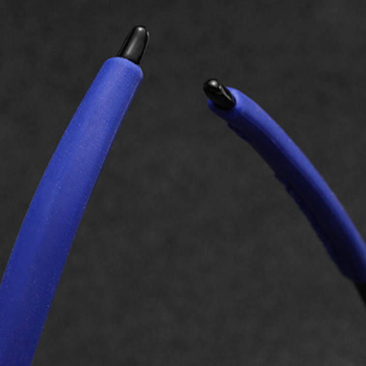 Close-up of the blue plastic arms of rectangular frame cycling sunglasses, featuring black tips and positioned against a dark, blurred background.