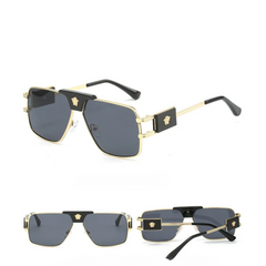 Three views of bold sunglasses with premium metal frames, black accents on the temples, and gray UV400 protection lenses. The temples feature a gold Medusa head emblem on black plaques for a striking, modern look.