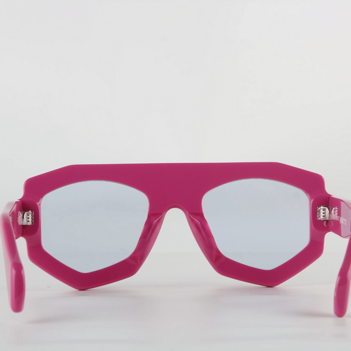 Bright pink futuristic sunglasses with thick geometric acetate frames and light-tinted lenses, featuring UV400 protection, shown facing forward against a plain white background.