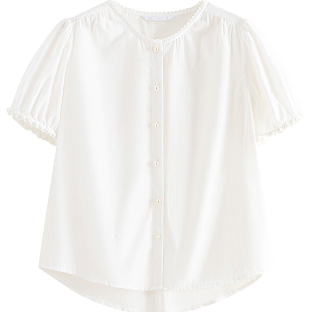 A white lace trim blouse featuring short puffed sleeves, a round neckline, small white buttons down the front, and delicate lace on the cuffs and collar—perfect as a versatile blouse for any occasion.