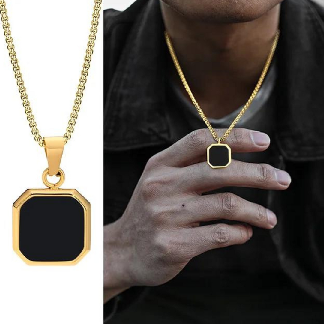 A gold chain necklace with a square Onyx Stone Amulet pendant is shown in close-up on the left and worn by a person in a dark jacket on the right. The person holds the collectable jewelry pendant between their fingers.