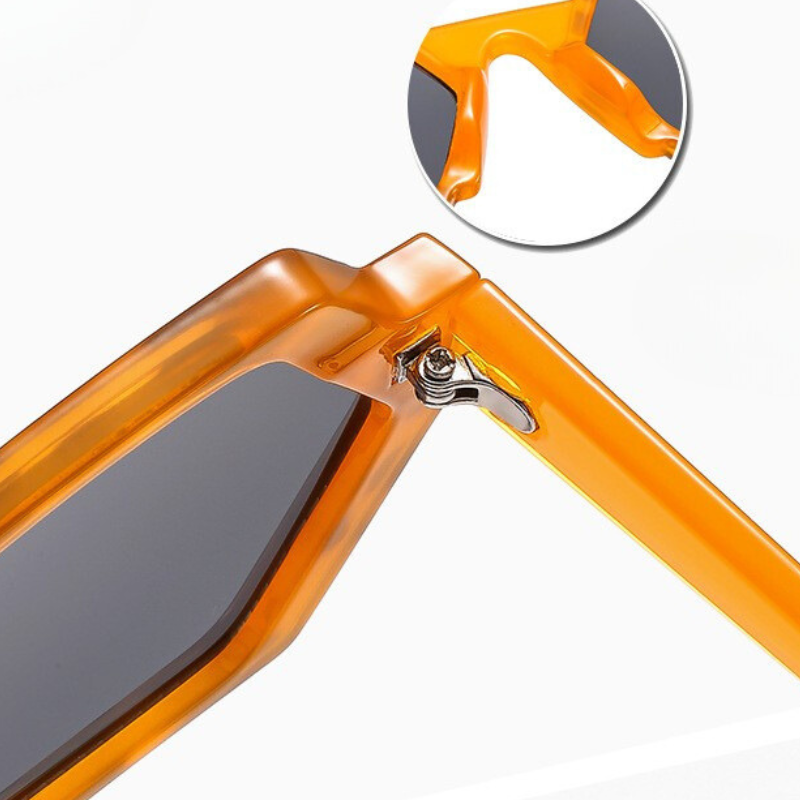 Close-up of orange sunglasses with dark lenses and a hexagonal frame, highlighting the hinge detail and frame design. An inset circle shows a magnified view of the corner and joint, emphasizing their trend-forward style and UV400 protection.