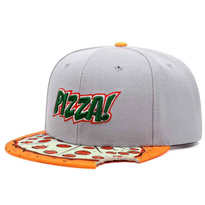 A gray snapback cap with the word PIZZA! in green and red letters on the front. This bite taken hat features a unique brim designed like a pizza slice, complete with toppings and a playful bite out of one edge—a true statement piece.
