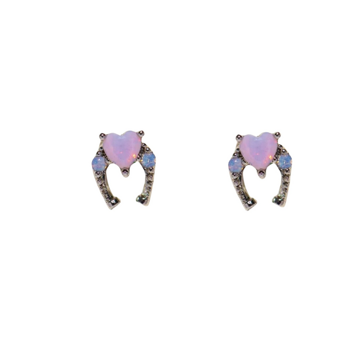 A pair of heart-shaped earrings featuring pink opal stones, accented with small blue and clear gemstones set in a curved silver design, displayed on a white background for an urban chic look.