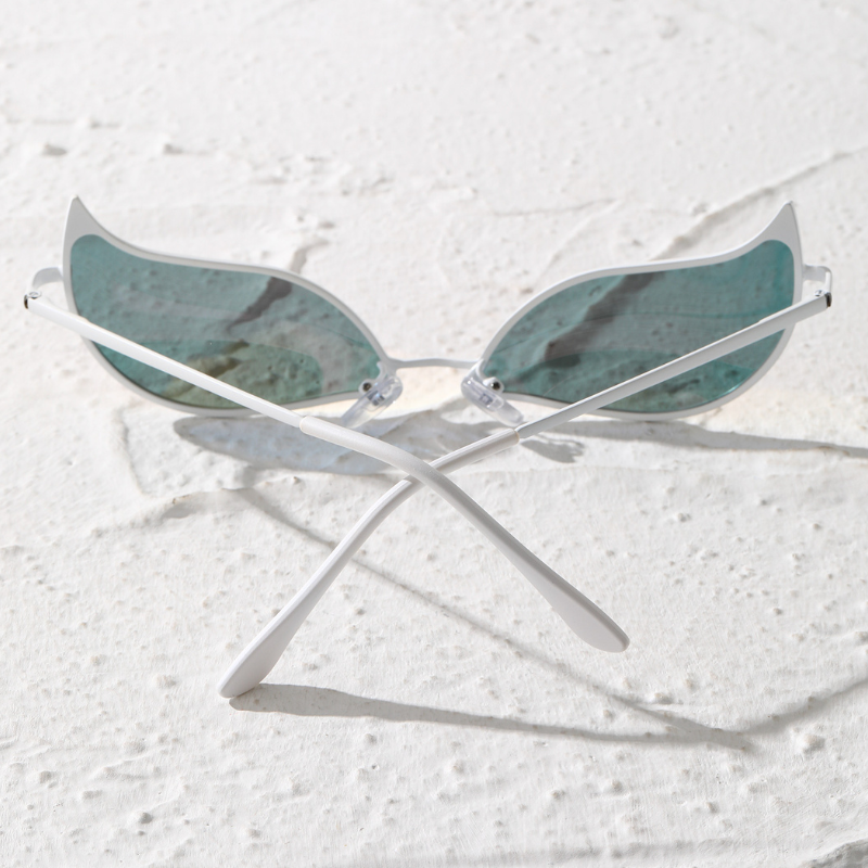 A pair of sunglasses with light blue, wing-shaped polarized lenses and white frames sits on a textured white surface with the lightweight arms crossed.