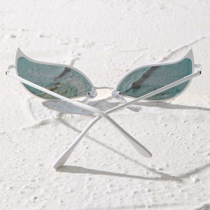 A pair of sunglasses with light blue, wing-shaped polarized lenses and white frames sits on a textured white surface with the lightweight arms crossed.