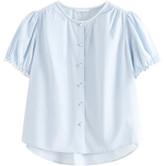 Light blue short-sleeved button-up blouse with puffed sleeves, white decorative trim at the collar and sleeve edges, and a slightly curved hem. This versatile blouse features soft, lightweight fabric for all-day comfort.