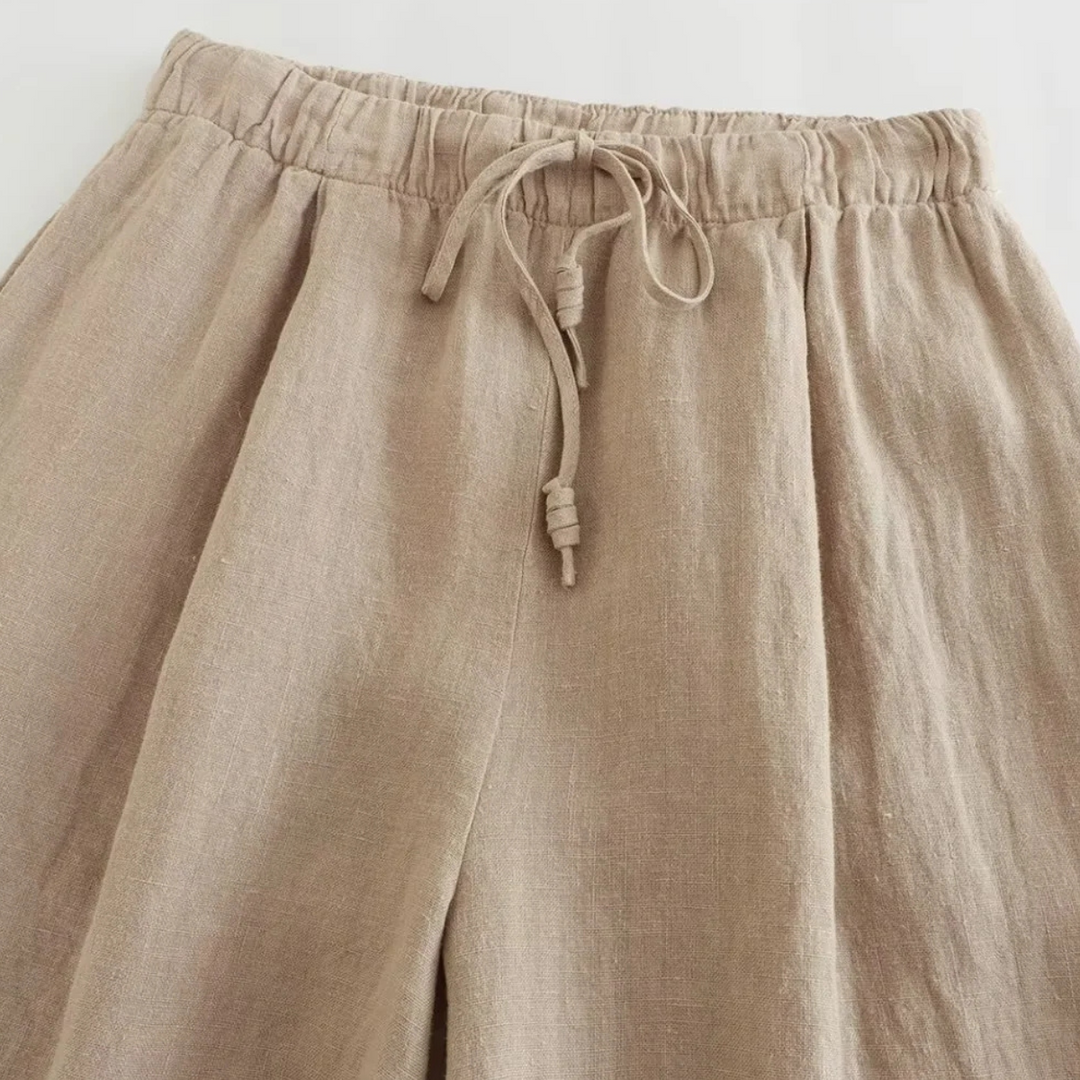 A beige wide-leg pants with a tie, perfect for effortless summer style.