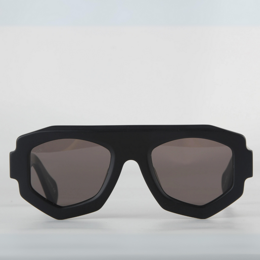 A black sunglasses with a geometric frame and UV400 protection, set against a white background.