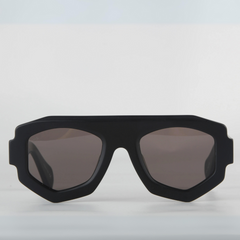 A black sunglasses with a geometric frame and UV400 protection, set against a white background.