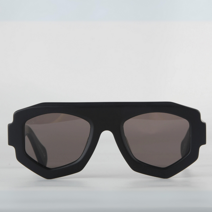A black sunglasses with a geometric frame and UV400 protection, set against a white background.