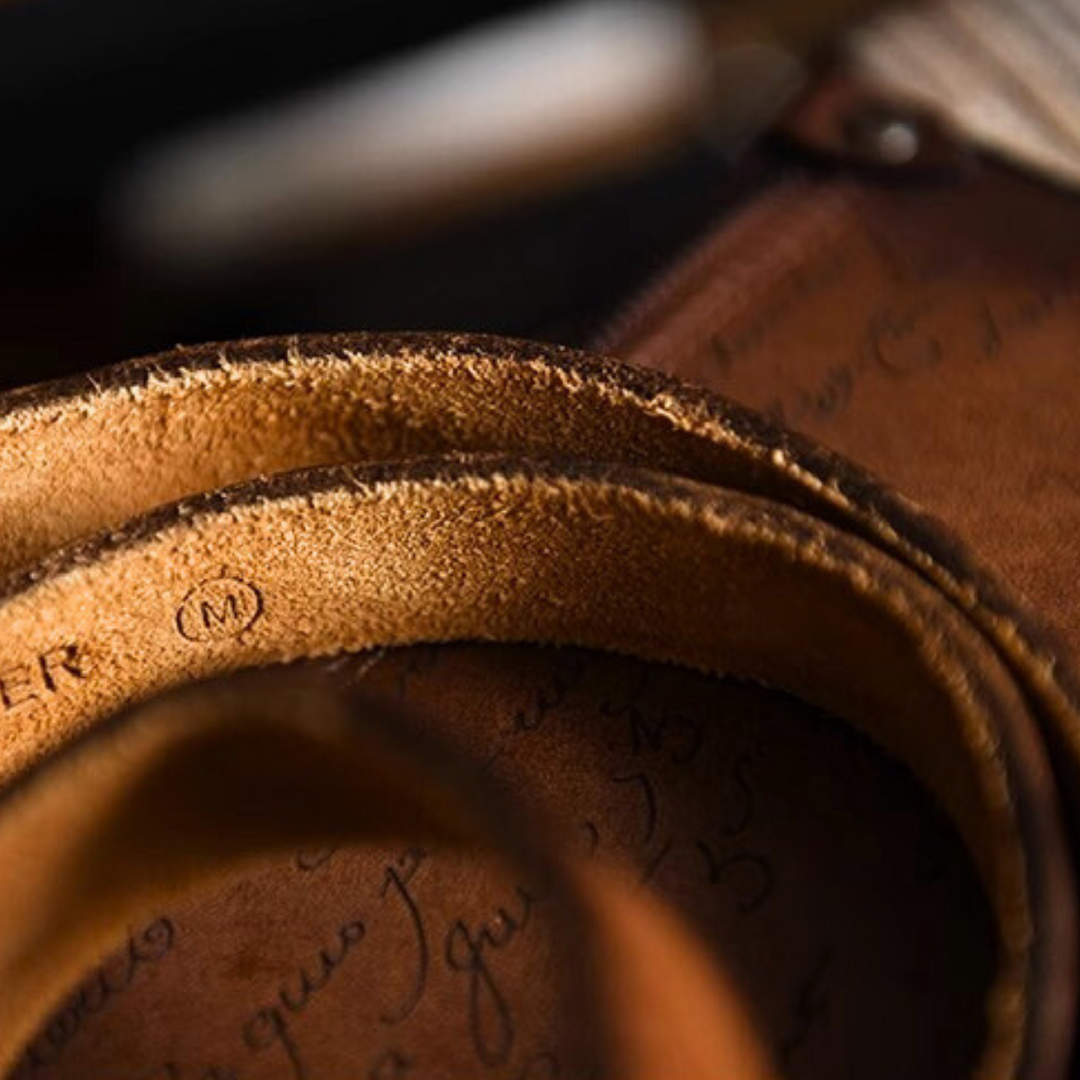 Close-up of the interior leather band of a hat, showing detailed texture and faint markings. The focus highlights genuine leather craftsmanship and material, with warm brown tones offering a touch of classic Southern style.