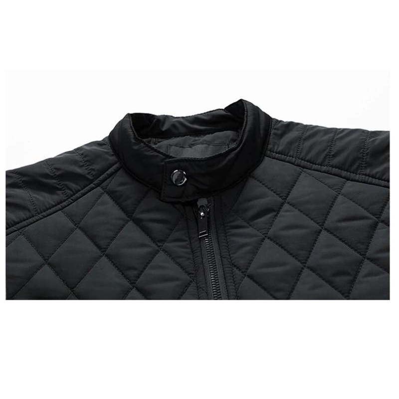 Close-up of a black quilted, wind-resistant jacket with a diamond pattern, featuring a stand collar with a snap button and a front zipper closure.