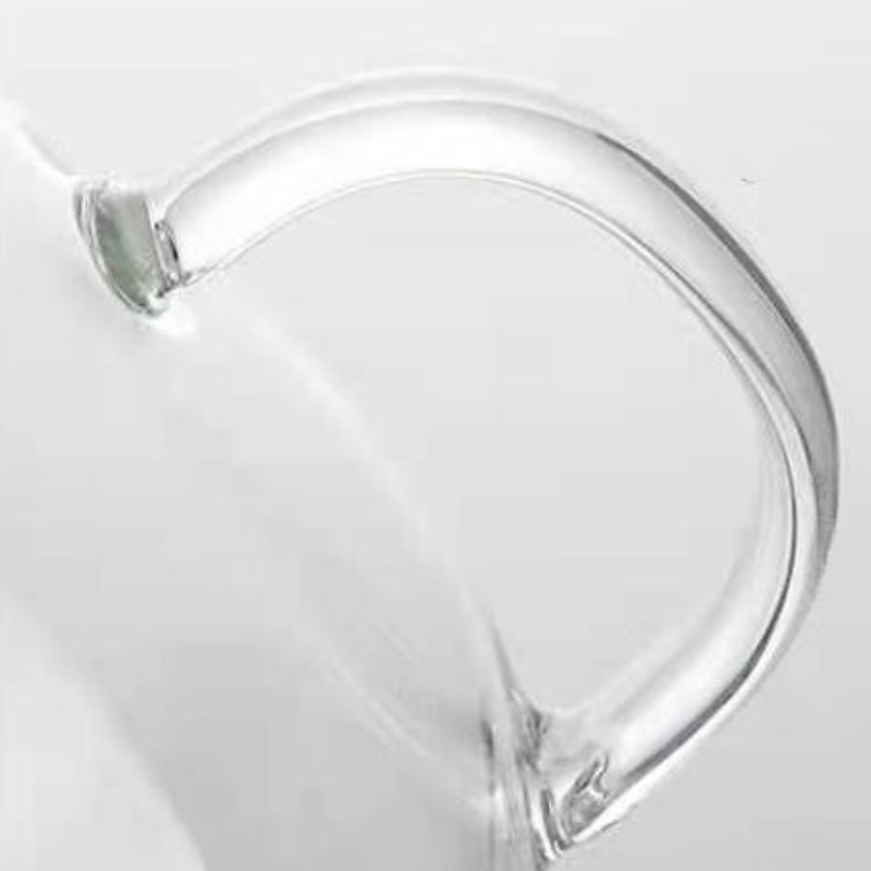 Close-up of an ergonomic handle seamlessly attached to a heat-resistant glass teapot, set against a plain white background.