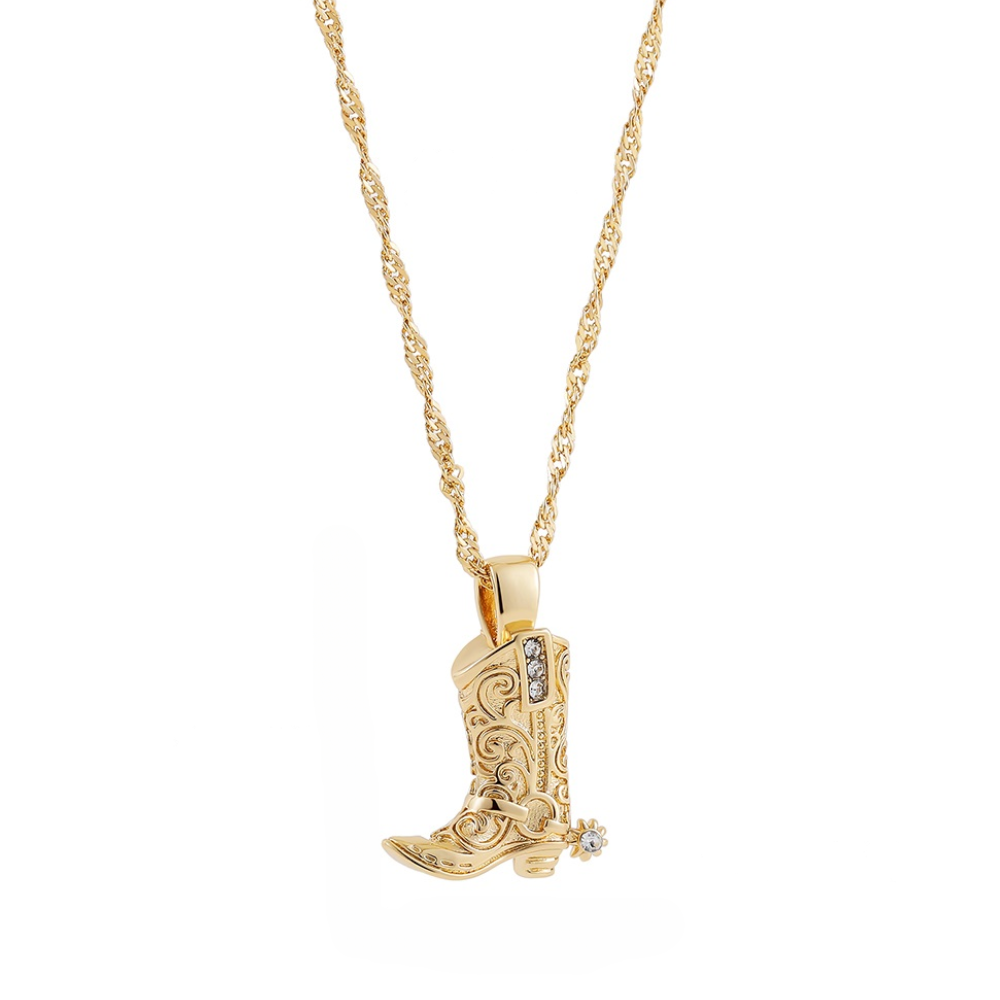 A gold chain necklace featuring a detailed cowboy boot pendant with engraved patterns and small gemstone accents, including one on the boot’s spur—a standout piece of western jewelry.