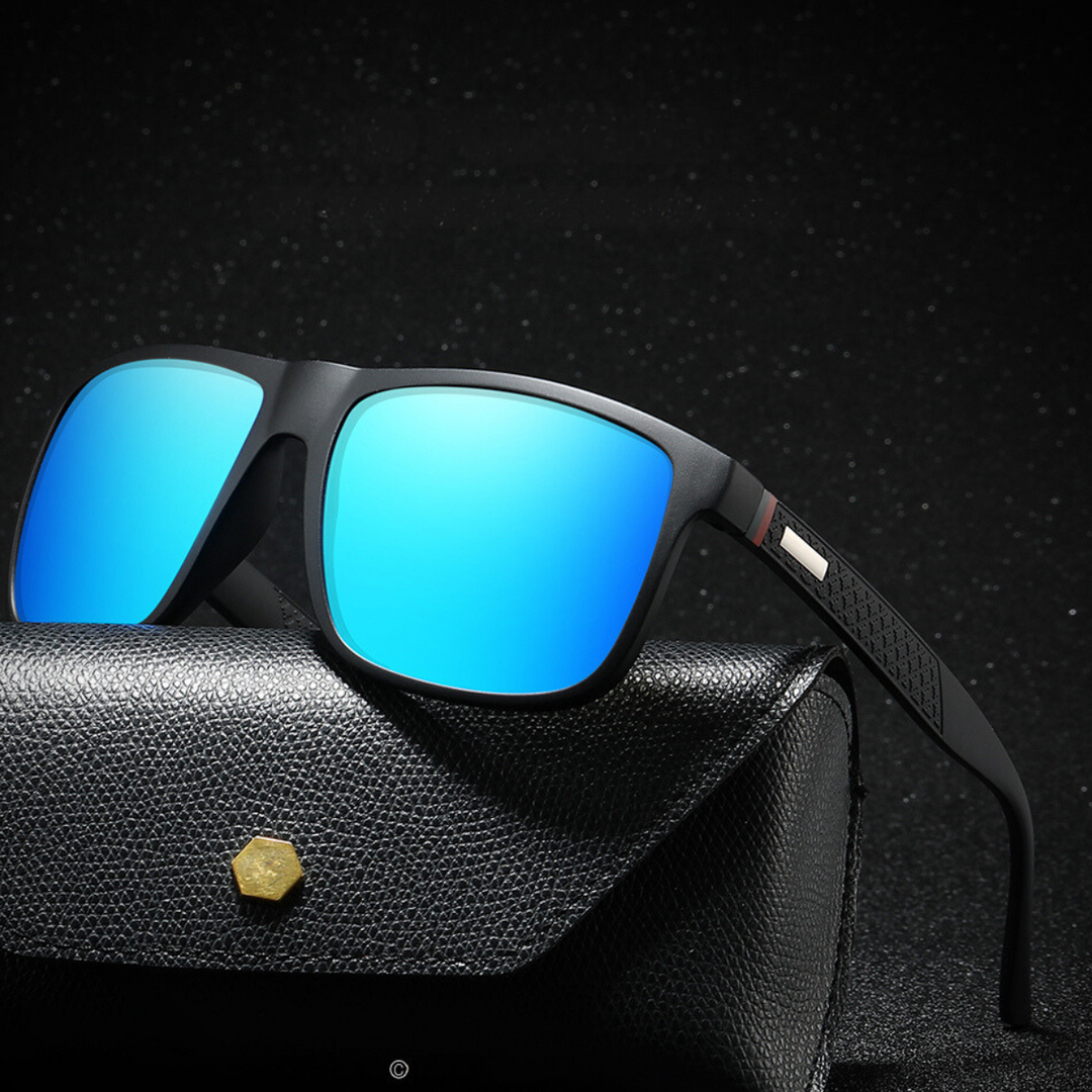 Sleek black UV400 sunglasses with bright blue reflective lenses rest on a textured black case with a gold button, set against a dark, sparkling background.