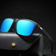 Sleek black UV400 sunglasses with bright blue reflective lenses rest on a textured black case with a gold button, set against a dark, sparkling background.