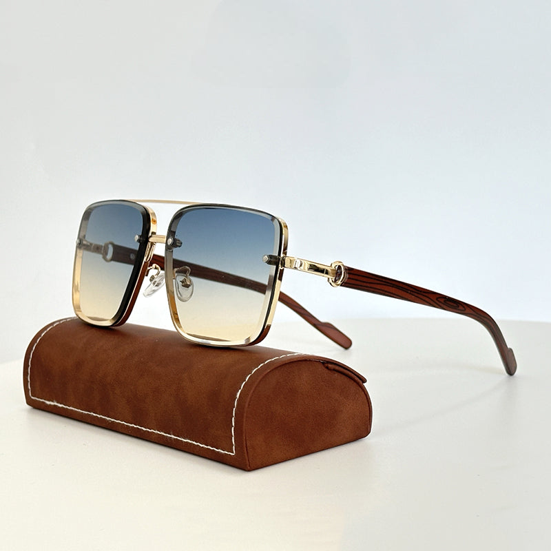 Gold-rimmed, square vintage sunglasses with gradient blue-to-clear lenses and UV400 protection rest on a brown suede case with white stitching, set against a plain white background.
