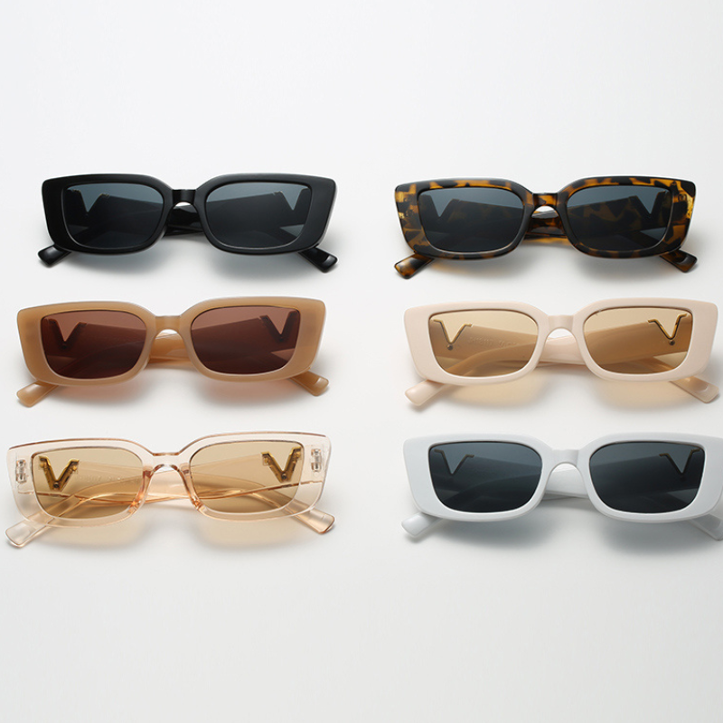 Six pairs of geometric frame sunglasses in black, tortoiseshell, brown, beige, light peach, and white are arranged in two rows on a white surface—each pair offering modern style and UV400 protection.