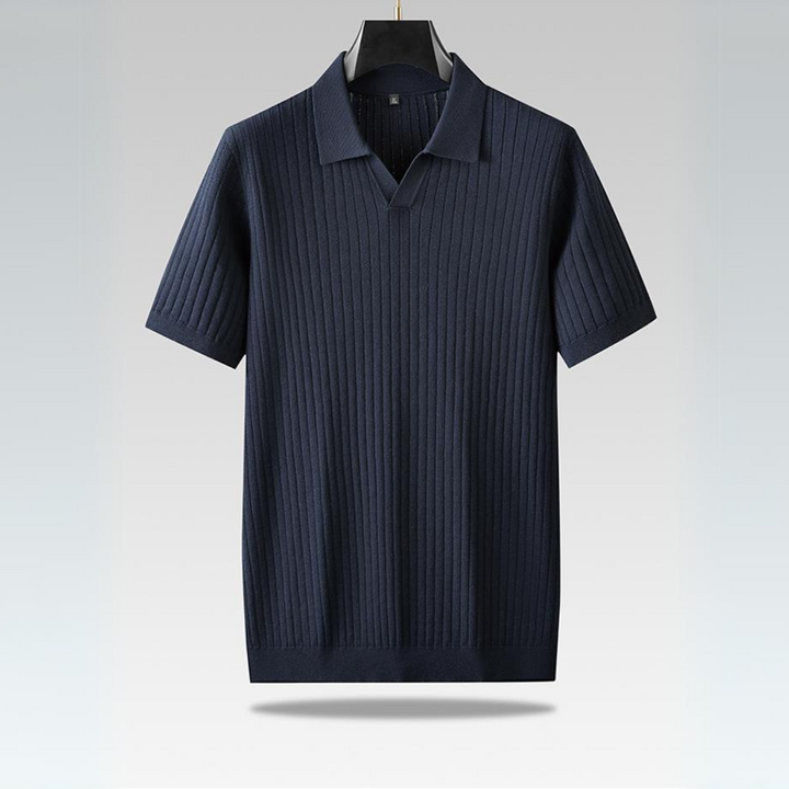 A navy blue, short-sleeve ribbed knit polo shirt hangs on a black hanger against a light gradient background. Perfect for the urban professional, this lightweight polo features vertical ribbed detailing and a classic collar.