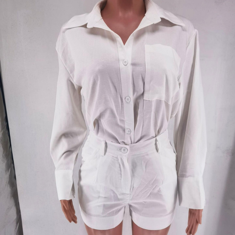 A mannequin dressed in a white sustainable linen button-up shirt with a collar and front pocket, paired with high-waisted white shorts. This elegant 2 piece set is displayed against a plain light background.