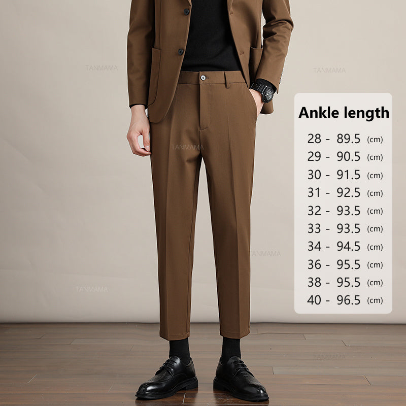 A person in a brown suit and black shoes stands indoors beside a size chart labeled Ankle length, listing pant lengths in centimeters for waist sizes 28 to 40—highlighting Mens Slim Casual Trousers made from premium fabric.