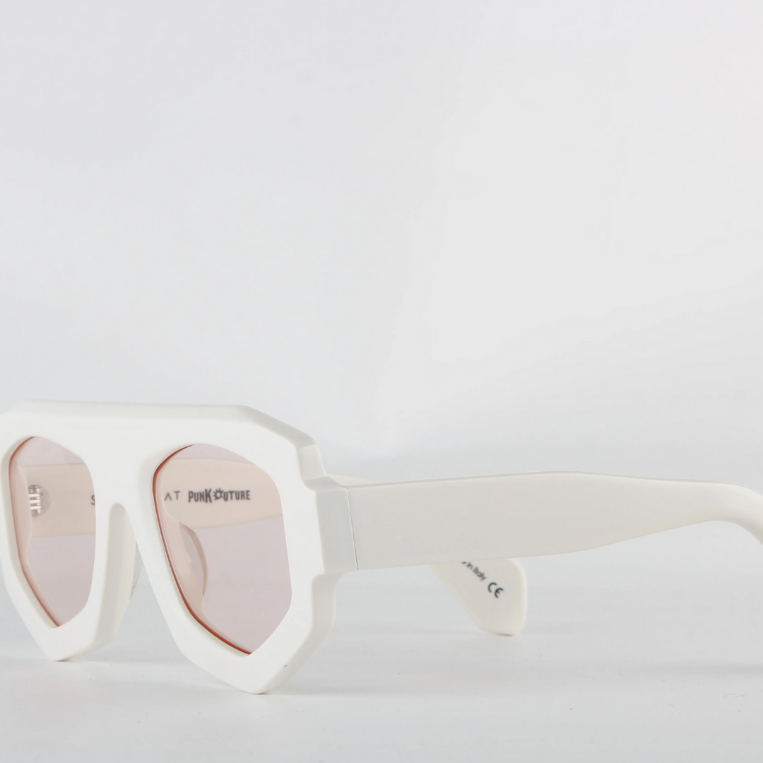 White oversized sunglasses with a bold geometric frame crafted from acetate and light pink-tinted lenses. The thick, angular edges create a modern look, while UV400 protection ensures stylish sun safety against a plain white background.