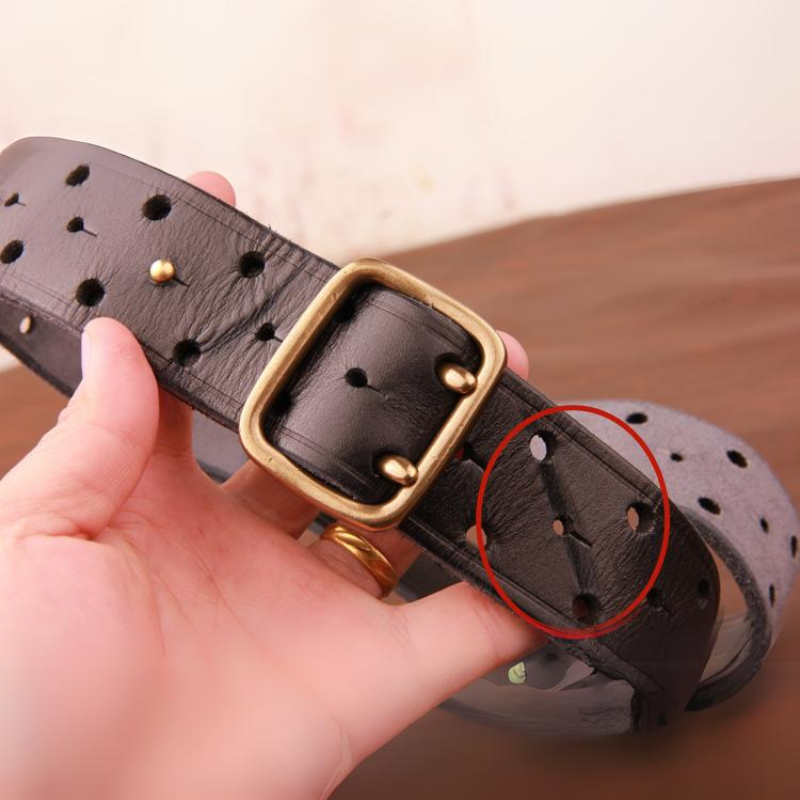 A hand holds a vintage leather belt with a brass buckle; a red circle highlights a section of small holes on the premium leather.