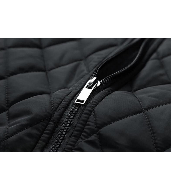 A close-up view of a partially unzipped black quilted slim-fit jacket, showing the silver zipper and the diamond pattern stitching on the wind-resistant material.