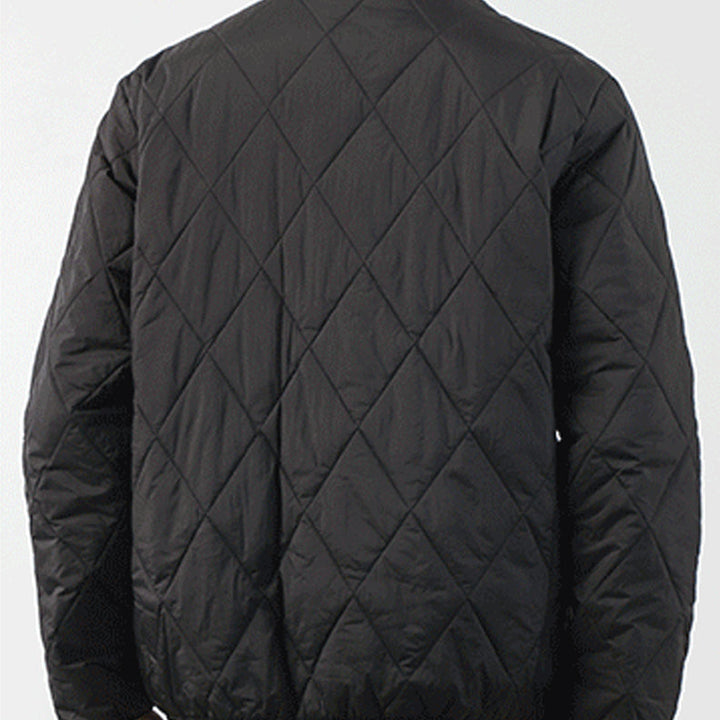 A person wearing a black padded jacket, shown from the back. The jacket features a diamond-stitched pattern and has a slightly loose fit. The background is plain and light-colored.