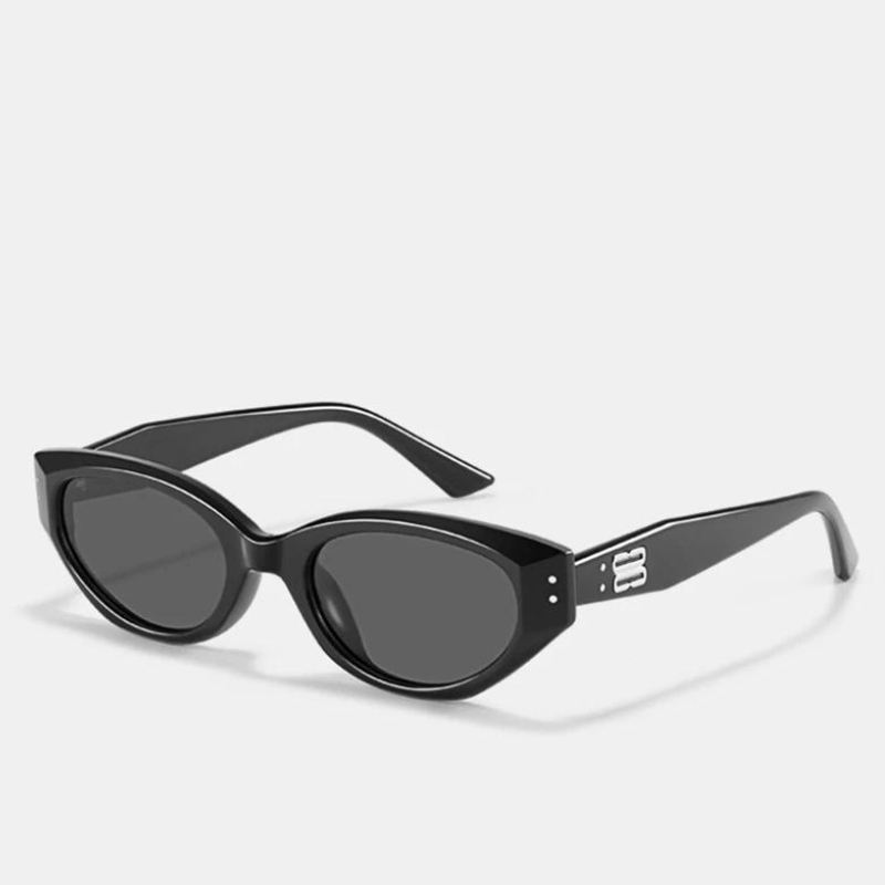 Black cat-eye sunglasses with dark, scratch-resistant lenses and thick translucent acetate frames, featuring a silver decorative detail on the arms. Offers UV400 protection. Displayed on a plain white background.